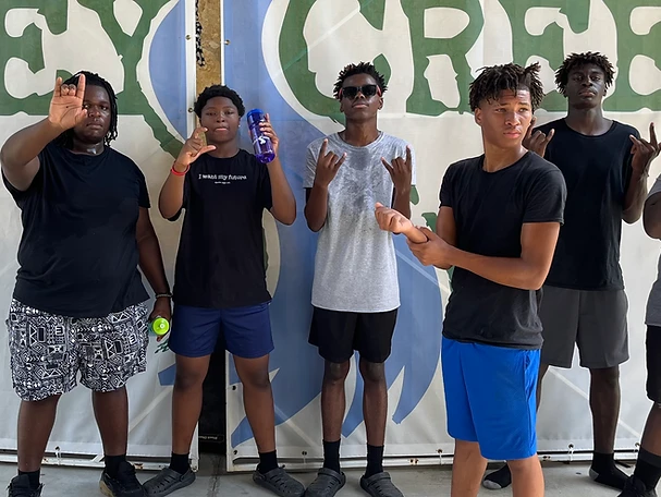 Five young men posing against a Sky Green banner