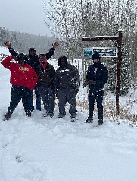 Five young people standing in the snow at Crooked Creek Ranch