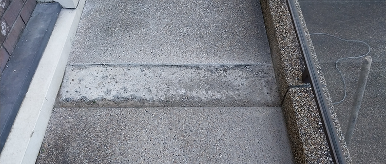 Walkway strip with the old surface removed, exposing the raw concrete base
