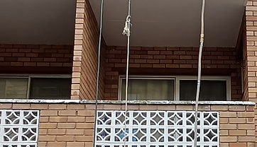 Three-storey residential brick building where balcony resurfacing work was carried out