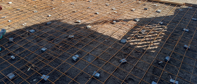Steel reinforcement mesh on spacer chairs inside timber formwork ready for a concrete pour