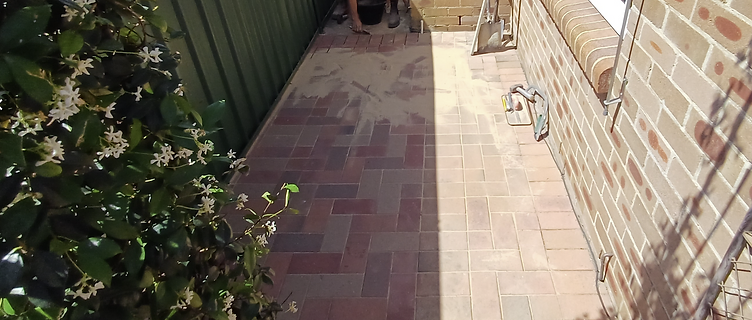 Brick paving partially laid with exposed sand base