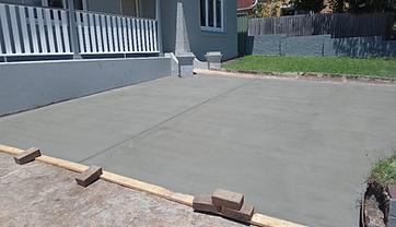 Freshly poured and finished concrete area with formwork