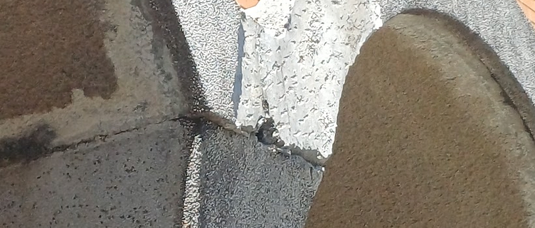 Broken pebblecrete arch capital with a chunk missing where two arches meet the column