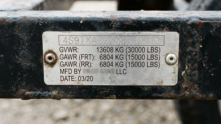 Close up of a trailer VIN plate showing GVWR and GAWR weight ratings