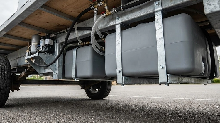 Fresh and gray water tanks installed under a food trailer