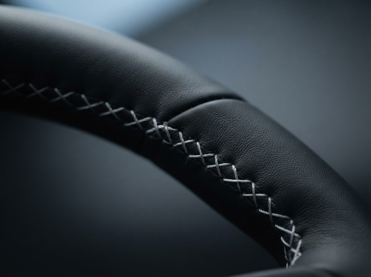 Macro detail of a premium sports car leather-stitched steering wheel