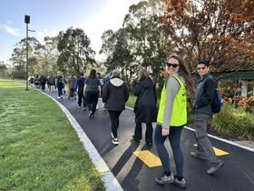 Volunteers walking along a paved path