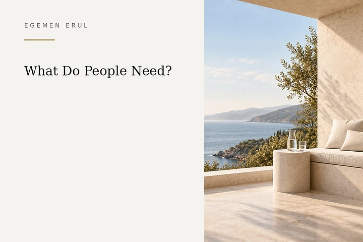 A pale limestone Mediterranean terrace overlooking the sea, with an ivory-cushioned bench, a glass water carafe and a drinking glass on the right, symbolising safety, rest and essential human needs.