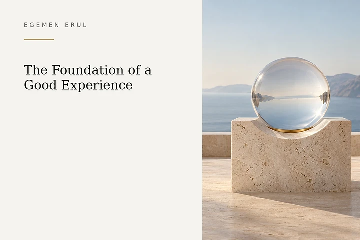 A transparent glass sphere with a fine champagne-gold ring rests on a pale Mediterranean stone pedestal, symbolising comfort, clarity and balance in a well-designed customer experience.