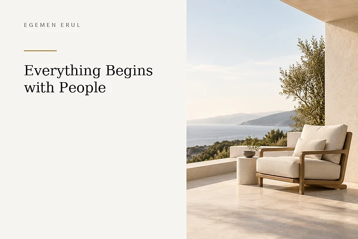 An empty lounge chair thoughtfully prepared for one person on a natural stone terrace overlooking the Mediterranean, symbolising trust, respect and making space for the individual in human-centred service.