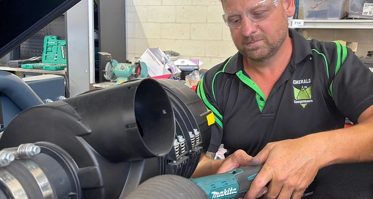 Emerald Air Compressors technician working on commercial compressor equipment