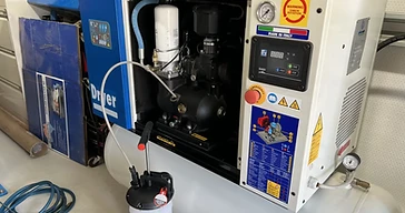 Air compressor servicing equipment during commercial compressor maintenance