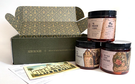 The complete Hotel Cal-Amity collection — collector box and three wax melt jars