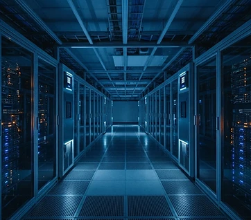 Blue-lit data center aisle between rows of server racks on a raised floor