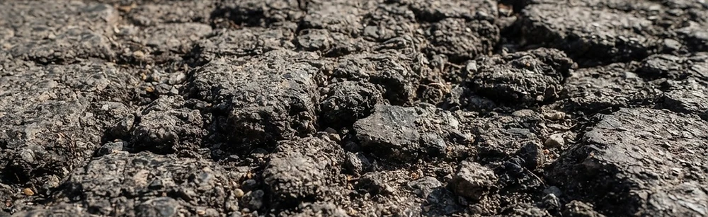 Cracked asphalt before treatment