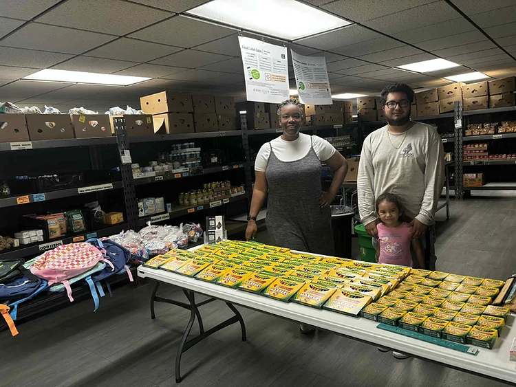 Top Dog Contracting Back-to-School Event — volunteers handing out school supplies
