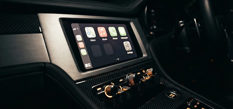 Glowing CarPlay dashboard in a custom vehicle cabin at night