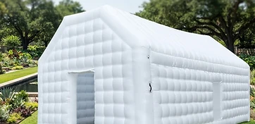 White inflatable modular pop-up pavilion with quilted chambers on a manicured Houston garden lawn