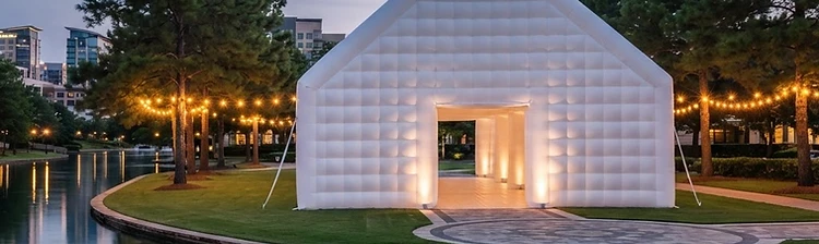 Illustration of a larger white inflatable wedding pavilion glowing at twilight