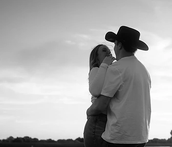 Couple in silhouette against a bright Texas sky