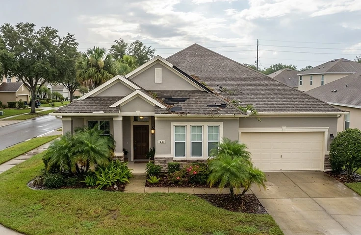 A Central Florida home with subtle signs of recent storm exposure on the roof