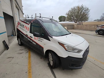 Save Pro Restoration branded van parked at a commercial building showing 24/7 emergency services wrap