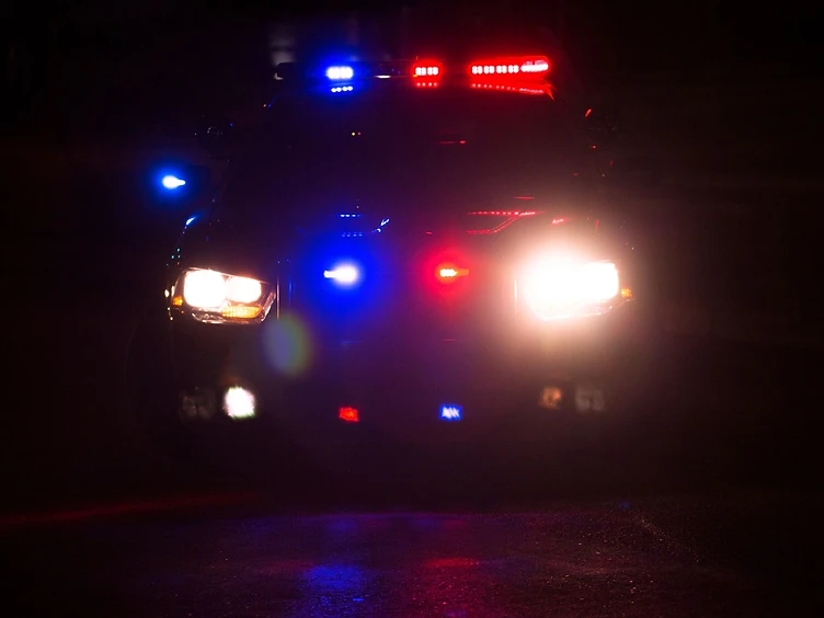 Police cruiser with emergency lights at night