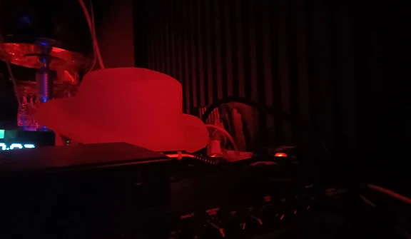 DJ and audio gear glowing red in the back room