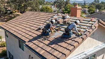 A professional construction worker inspecting the roof of a residential property in a suburban California neighborhood.