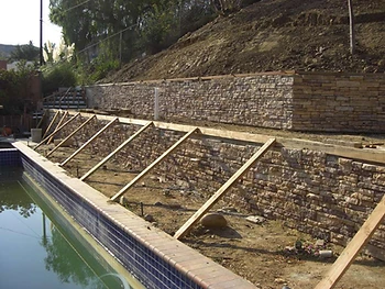 Stone Veneer Wall Progress with Temporary Bracing