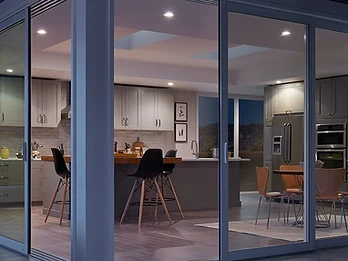 Evening view of installed patio doors showcasing modern hardware and clean frames