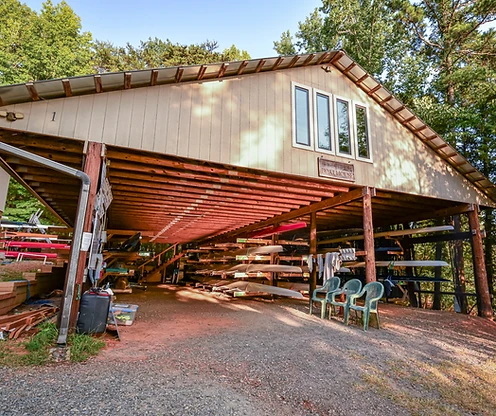 Boathouse 1 — racked shells under the roof