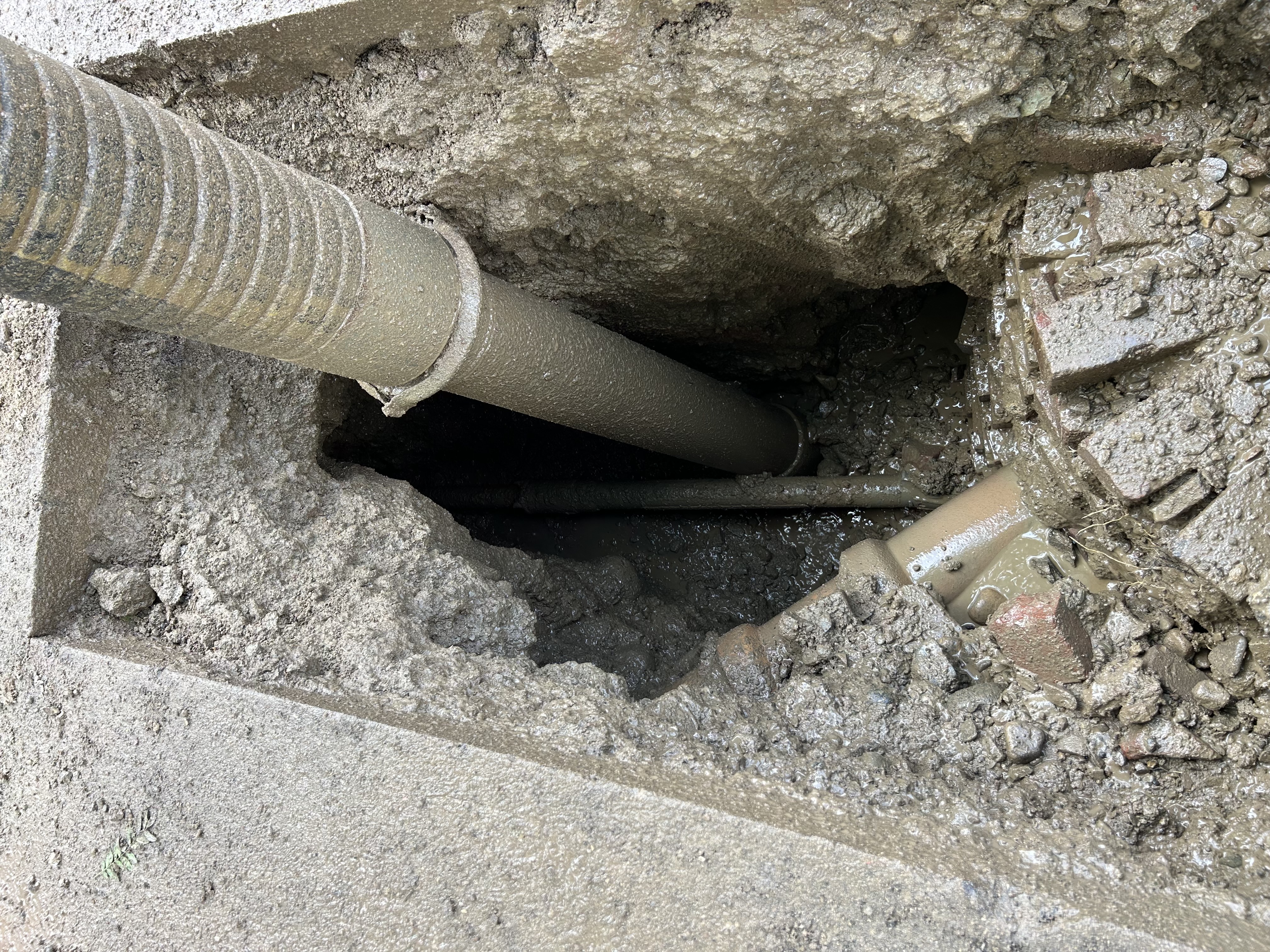 Hydro excavation exposing a buried utility in a trench