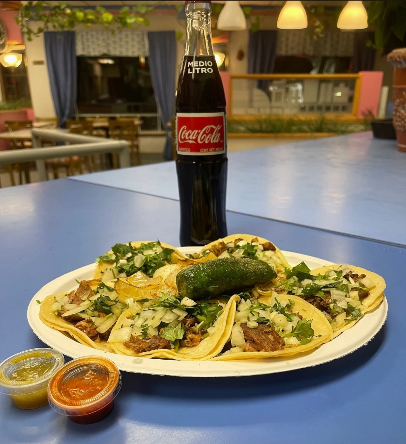 Street tacos with onions, cilantro and salsas