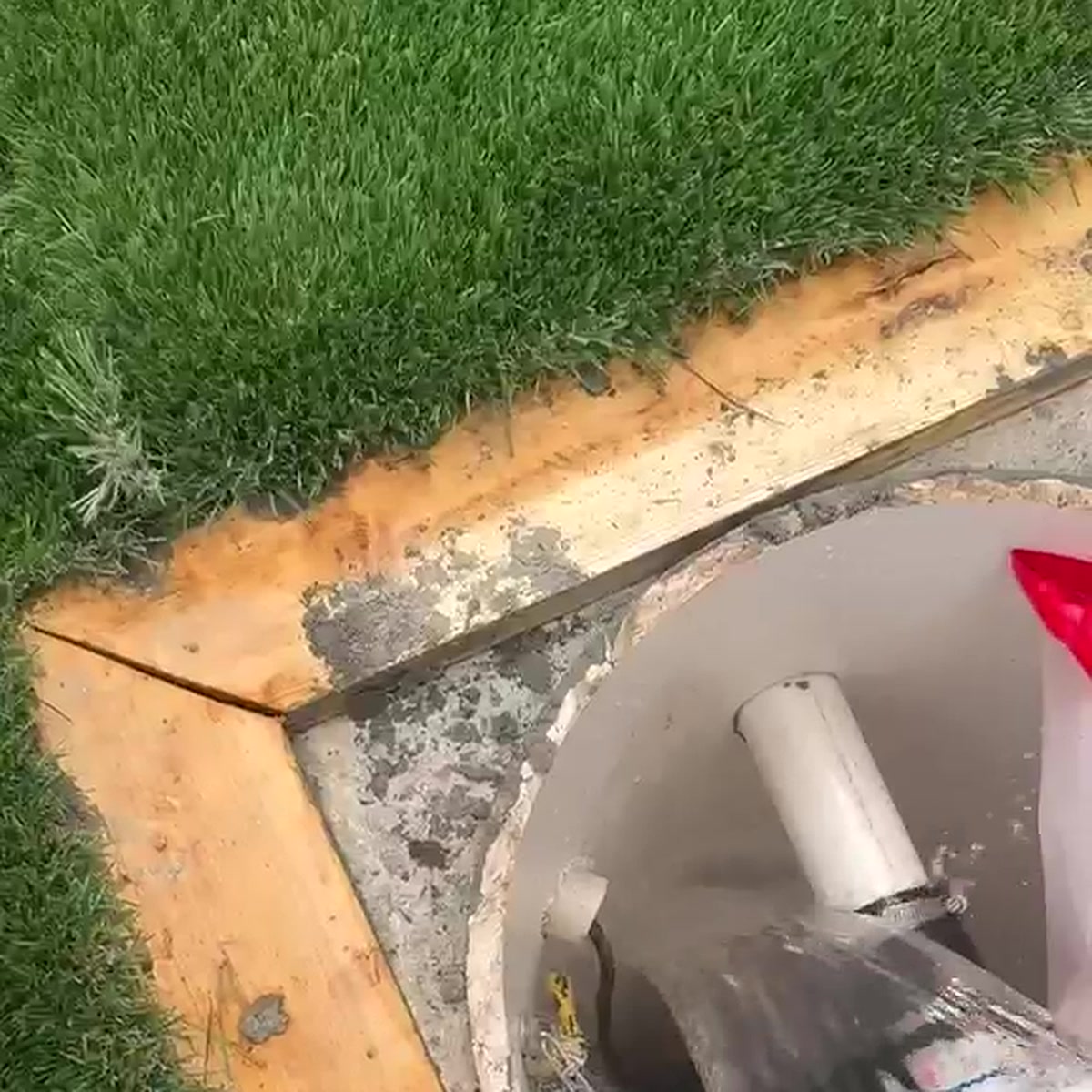 Noble Waterproofing access panel installation with turf surround and concrete base on a San Fernando Valley waterproofing project