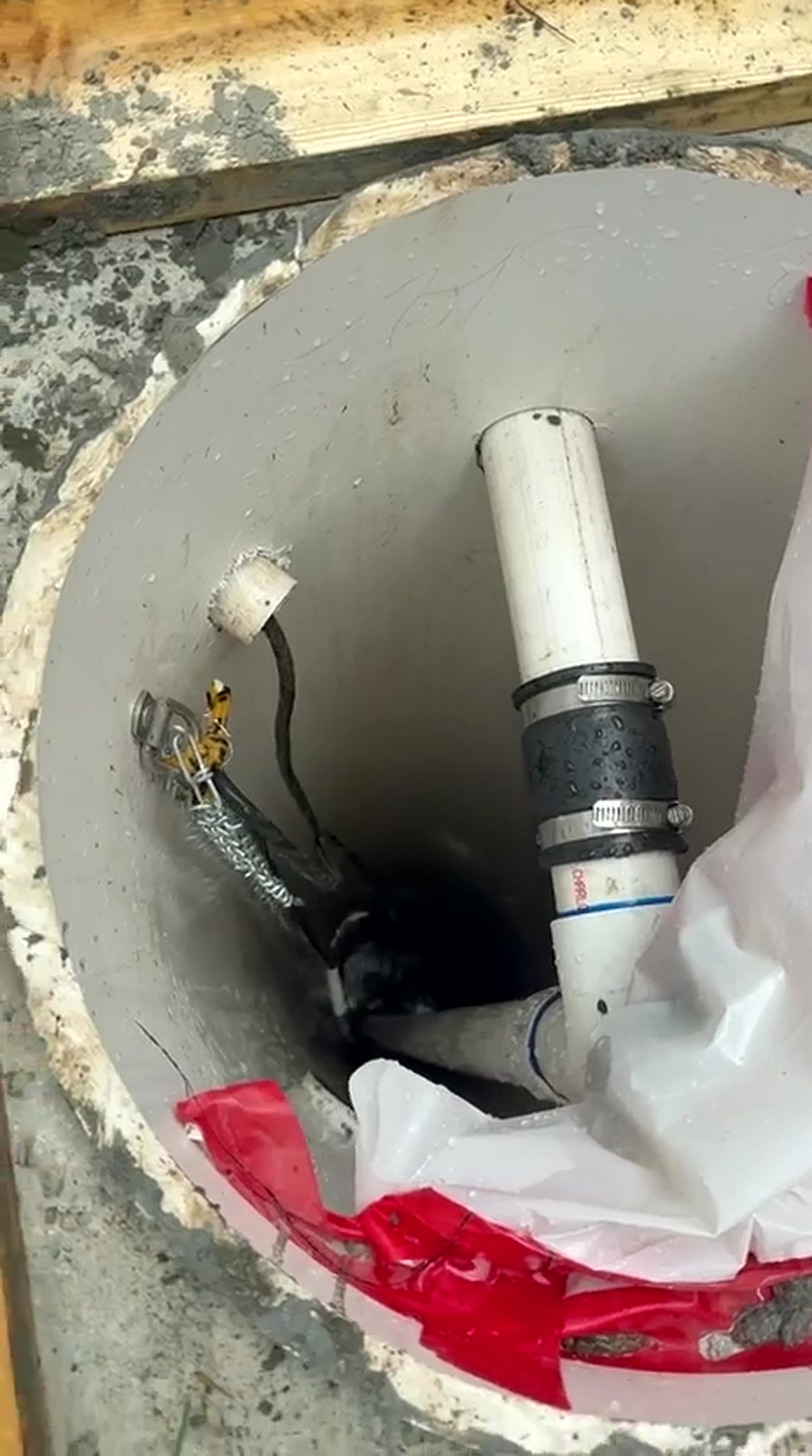 Noble Waterproofing drain basin installation in a concrete slab with PVC pipe and rubber coupling in the San Fernando Valley
