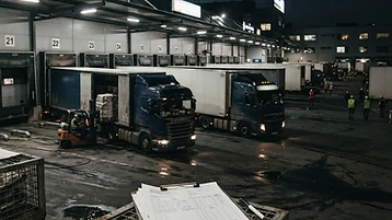 Trucks at a distribution center with freight documentation and transportation invoices