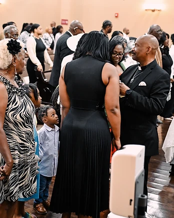 Congregation standing together in warm fellowship during a service
