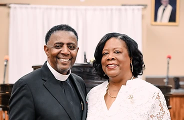Pastor and church leader posing together in the sanctuary