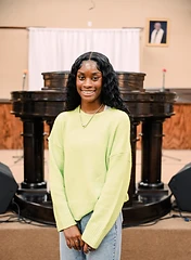 Young church member smiling in front of the pulpit
