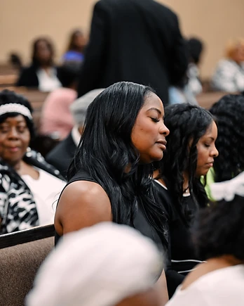 Church member in a moment of prayer during Sunday service