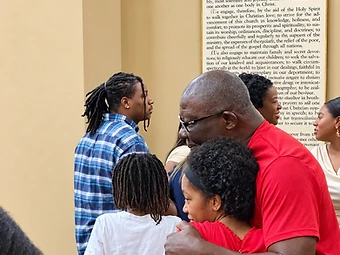 Church members sharing an embrace during fellowship