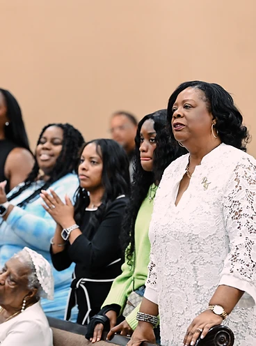 Congregation worshipping together with hands raised