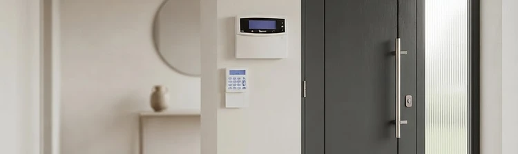 Pyronix wireless alarm control panel and keypad installed beside a front door