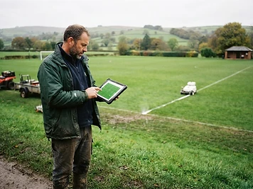Robotic GPS line marking in progress on a sports field