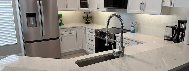 Luxury solar-drenched kitchen with marble island and floor-to-ceiling windows