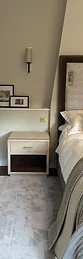 Bedside table beside bed