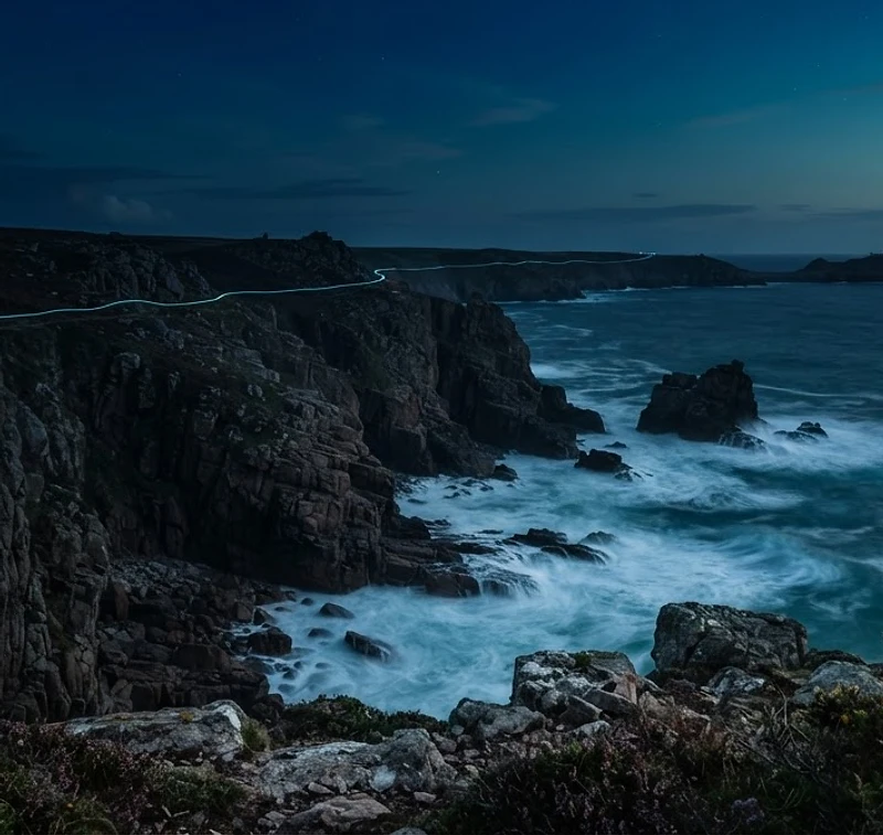 Cornish granite coastline at dusk with a cyan light trail following the cliffs