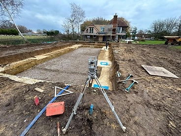 Excavated pool base with crushed stone and survey setting out